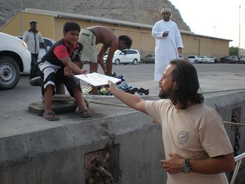 Distributing educational materials to local children.