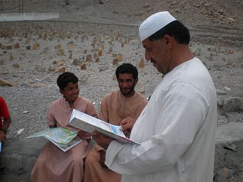 Local children & adults with educational books.