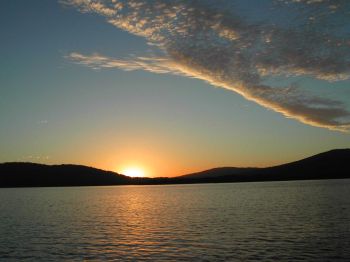 Sunset over forest & lake.